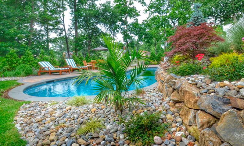 Rock garden and retaining wall next to a swimming pool