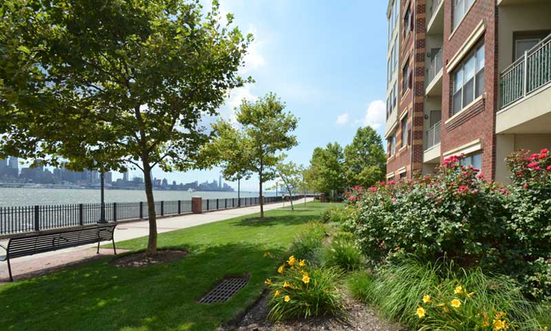 A townhouse community with walking path along the Hudson River