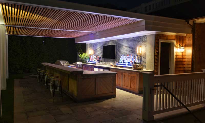 Outdoor bar and kitchen with video screen and lighting