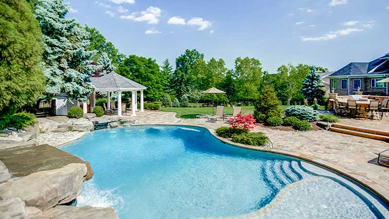 Beautifully designed and landscaped yard with pool, patio, and gazebo