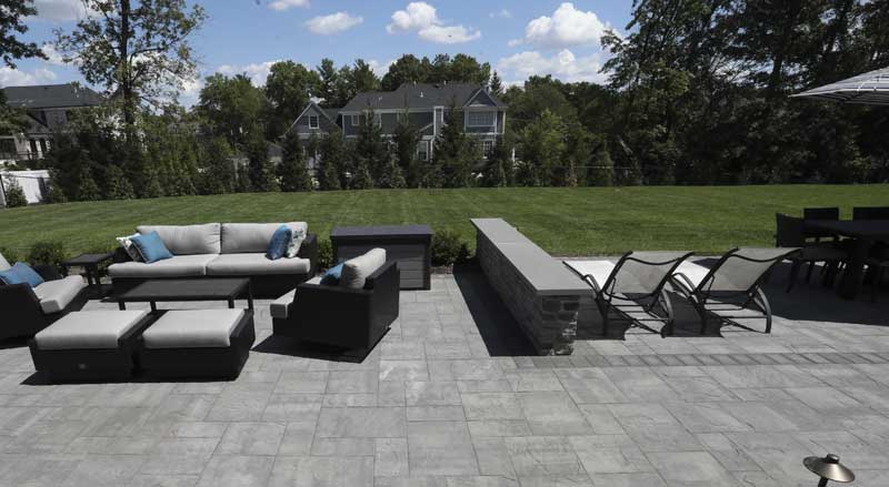 An expansive stone patio with outdoor furniture