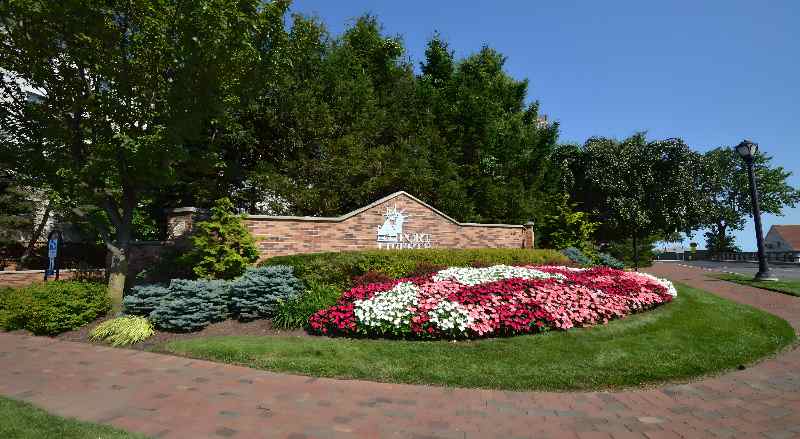 Beautiful flowers planted at the entrance sign of Port Liberte HOA community