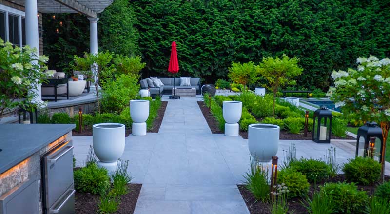 beautiful backyard featuring hardscaping pathways and green landscaping