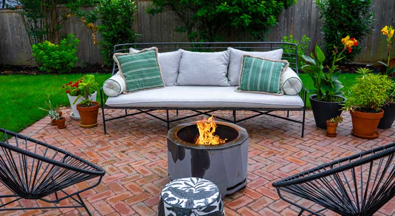 Cozy backyard patio with fire pit and seating area, designed for fall outdoor enjoyment