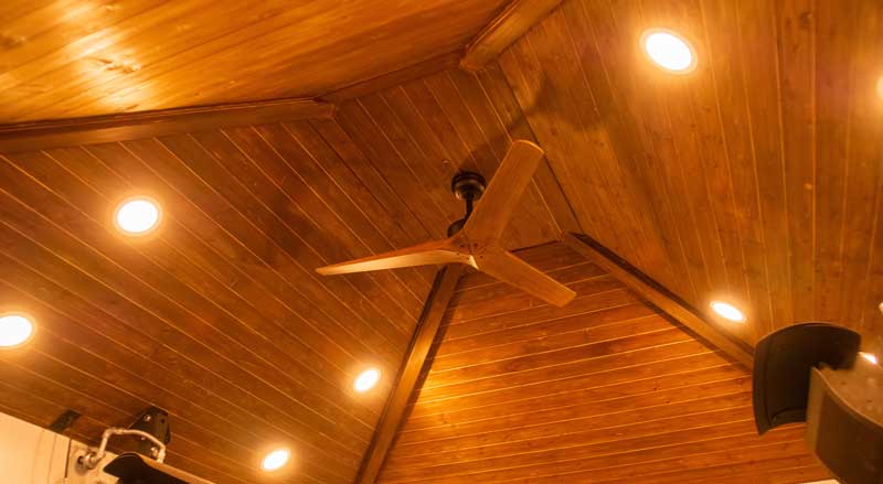 Close-up of pavilion ceiling with recessed lighting and ceiling fan, highlighting craftsmanship and comfort in outdoor design