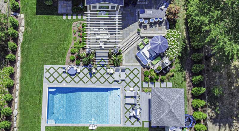 Aerial view of luxury backyard master plan with pool, pergola, outdoor dining areas, and structured garden layout