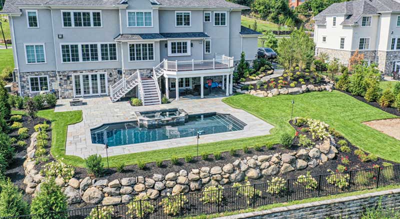 Backyard with retaining walls, pool, and sloped grading designed for proper drainage and erosion control