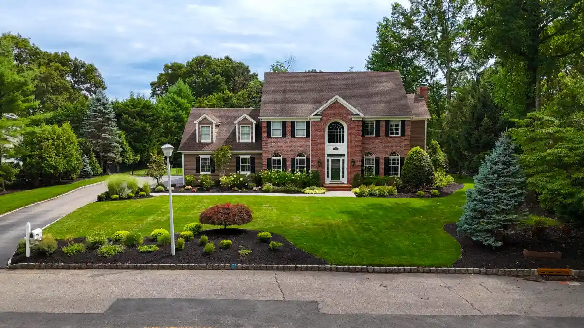 Front yard curb appeal landscape design with lawn, foundation plantings, ornamental trees, and clean bed lines at a Northern New Jersey home.