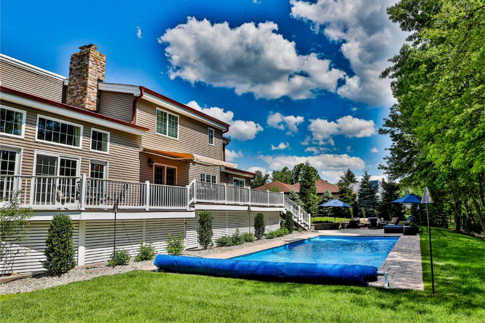 Custom swimming pool with backyard landscape installation