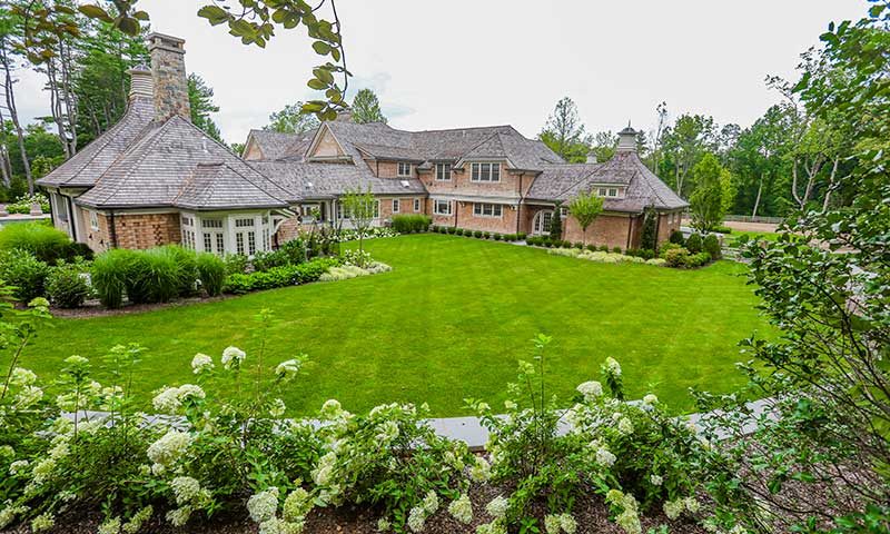 Beautiful back yard with lush grass and landscaping
