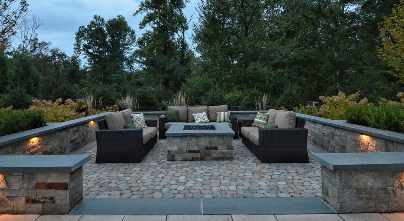 Outdoor Conversation Area with Firepit and Seating Wall