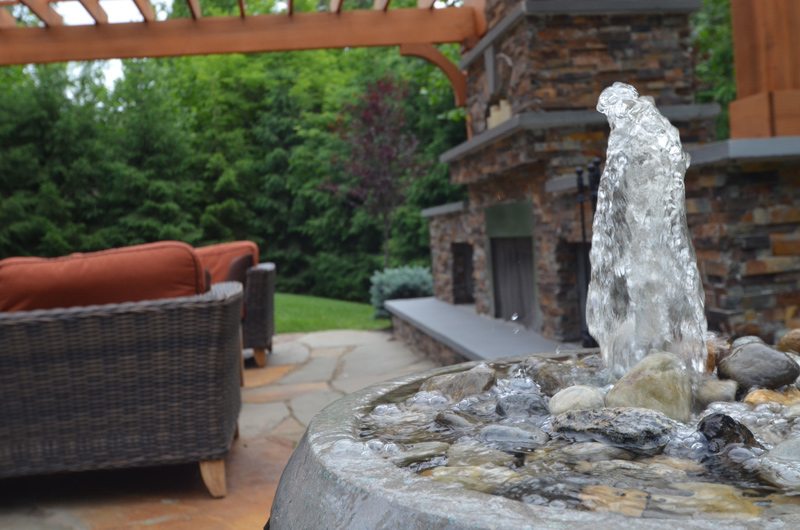 Outdoor Fireplace with Seating and Container Fountain